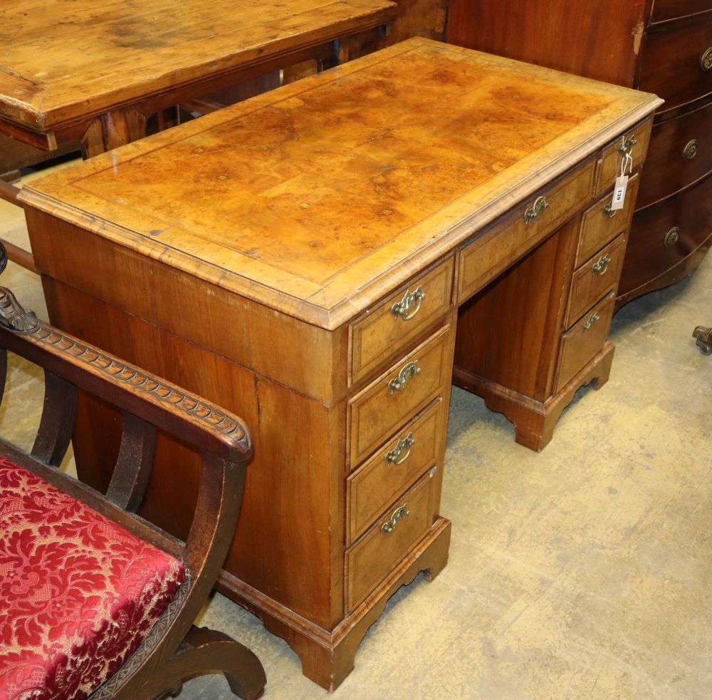 A George I style burr walnut pedestal desk, W.115cm, D.62cm, H.73cm